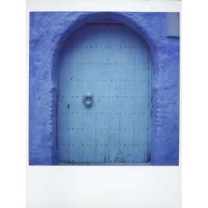 Polaroid of Traditional Painted Blue Door Against Bluewashed Wall 
