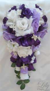   rose bud accented with white stephanotis and purple bow and tails