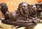 Pair of Cast Bronze Laying Lion Statues  