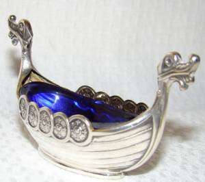   this salt dish is made out of solid silver with a cobalt blue bristol