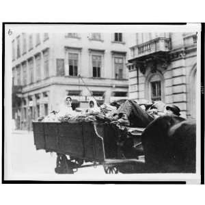  Man lying down on wagon seat,two women in back of wagon 