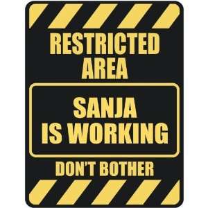   RESTRICTED AREA SANJA IS WORKING  PARKING SIGN