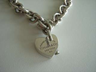   Tiffanys Return To Tiffany lock charm on a cable link bracelet