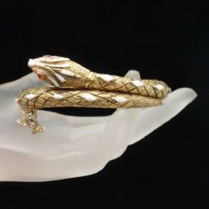 Goldtone snake with enamel accents including red tongue. Hinged for 