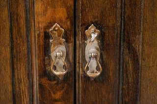 Brass drop pulls can be found on both sets of doors. They are a 
