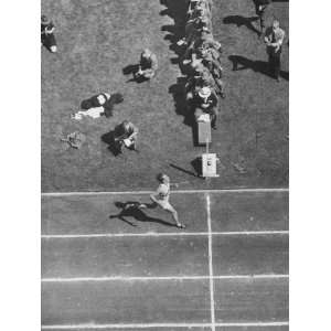 Roger Bannister Finishing a Race During the British Empire Games 